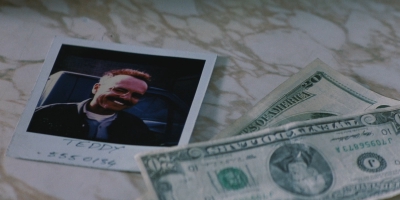 Joe Pantoliano on a Polaroid in a screenshot from Christopher Nolan's *Memento*